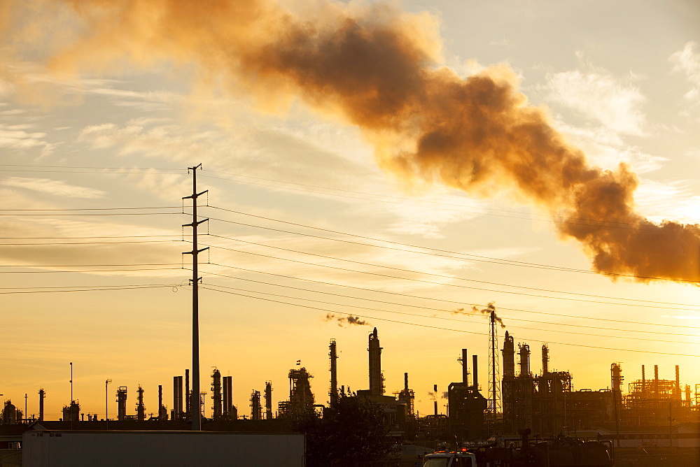 The tar sands upgrader plant at the Syncrude mine north of Fort McMurray at sunset, Alberta, Canada, North America