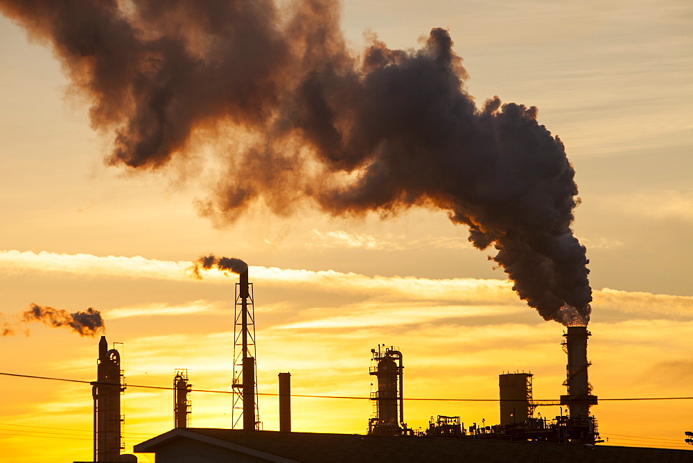 The tar sands upgrader plant at the Syncrude mine north of Fort McMurray at sunset, Alberta, Canada, North America