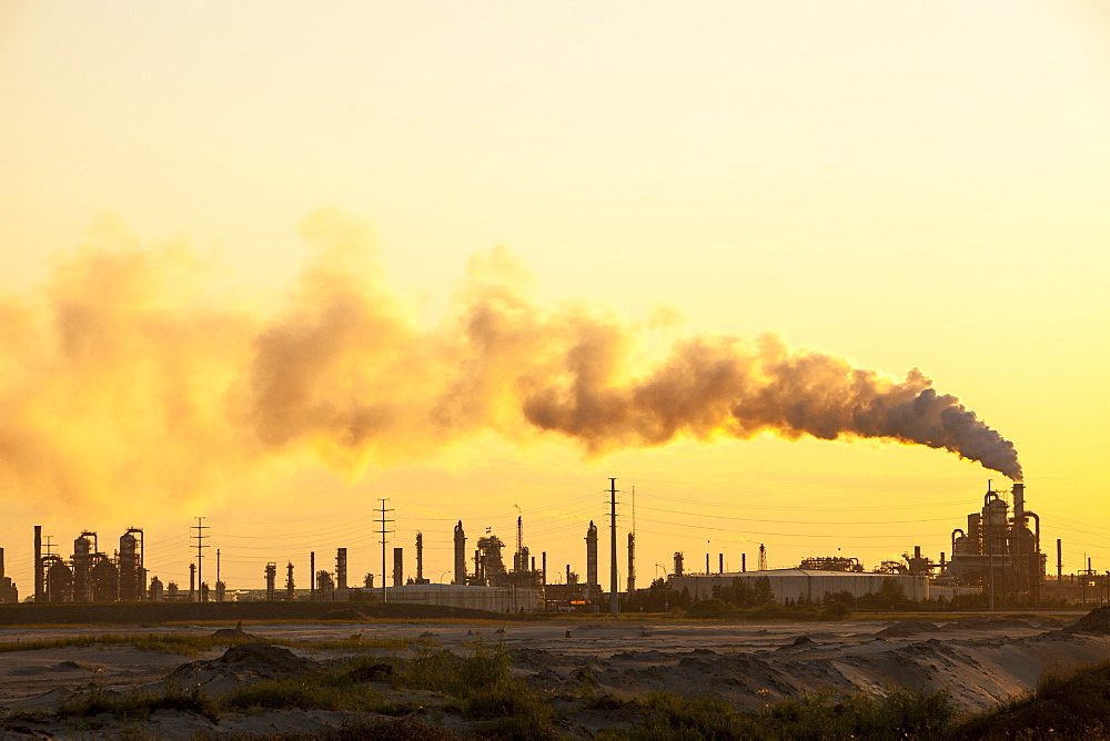 The tar sands upgrader plant at the Syncrude mine north of Fort McMurray at sunset, Alberta, Canada, North America