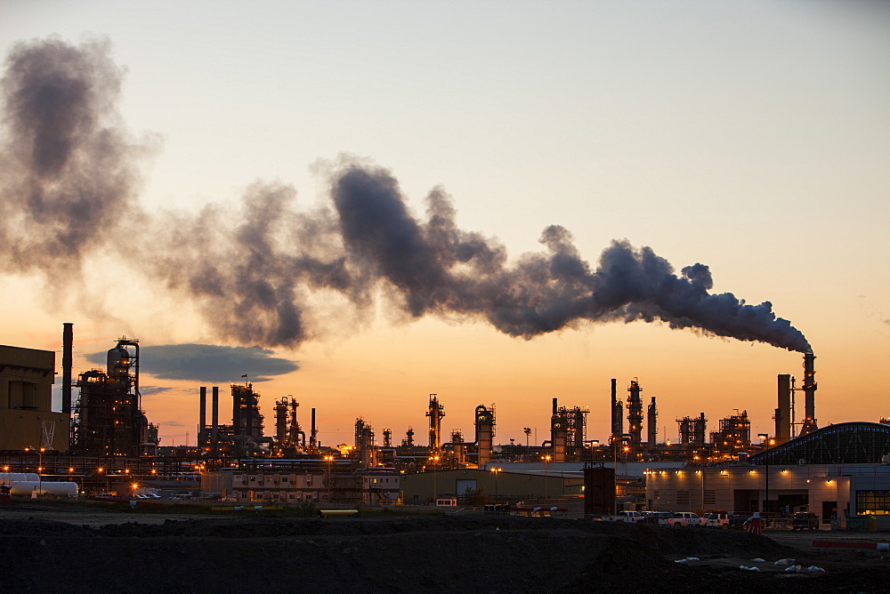 The tar sands upgrader plant at the Syncrude mine north of Fort McMurray at sunset, Alberta, Canada, North America