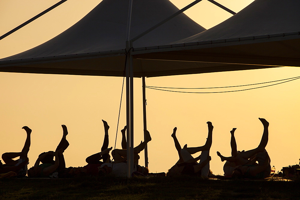 A stretch and relax class at sunset at a holiday complex in Myrina on Lemnos, Greek Islands, Greece, Europe