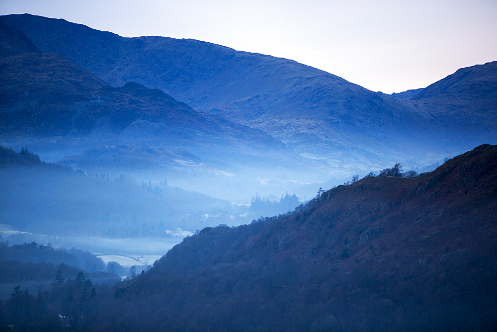 Valley mist forming at sunset near Ambleside, Lake District National Park, Cumbria, England, United Kingdom, Europe