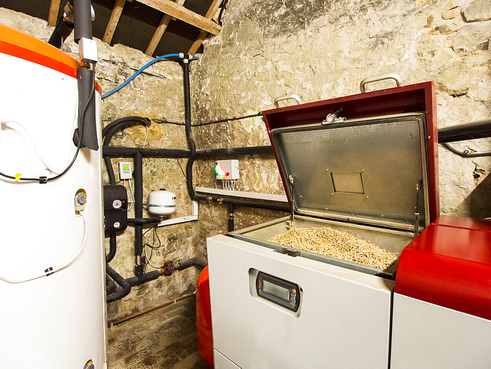 A biofuel boiler that burns wood pellets and a large hot water tank, United Kingdom, Europe