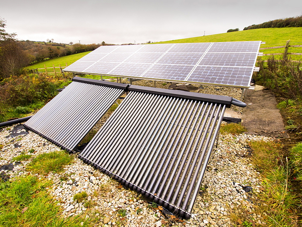 Solar photo voltaic panels and solar thermal panels providing electricity and hot water for a farm house on Bodmin Moor, Cornwall, England, United Kingdom, Europe