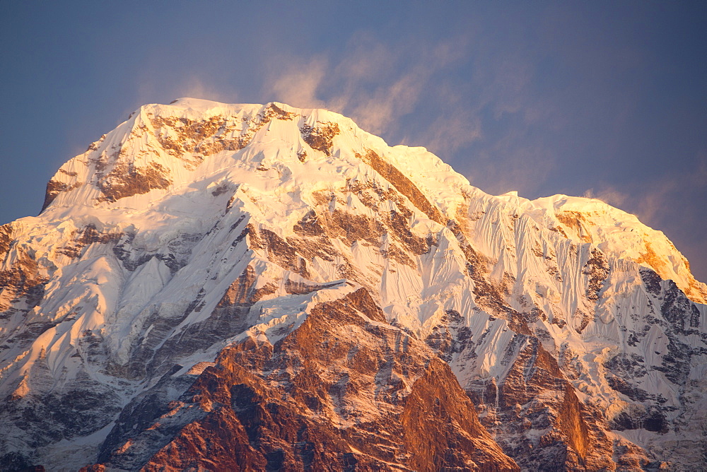 Annapurna South with high winds blowing spindrift off the summit at sunset, Annapurna Sanctuary, Nepalese Himalayas, Nepal, Asia