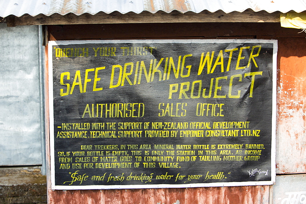 A sign about a safe drinking water project in the Annapurna Sanctuary, Himalayas, Nepal, Asia