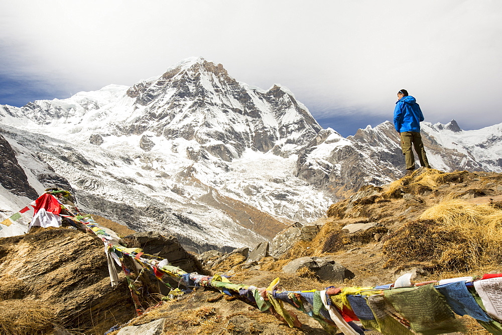 Trekkers at Annapurna base camp at 4130 metres looking towards Annapurna South, Annapurna Sanctuary, Himalayas, Nepal, Asia