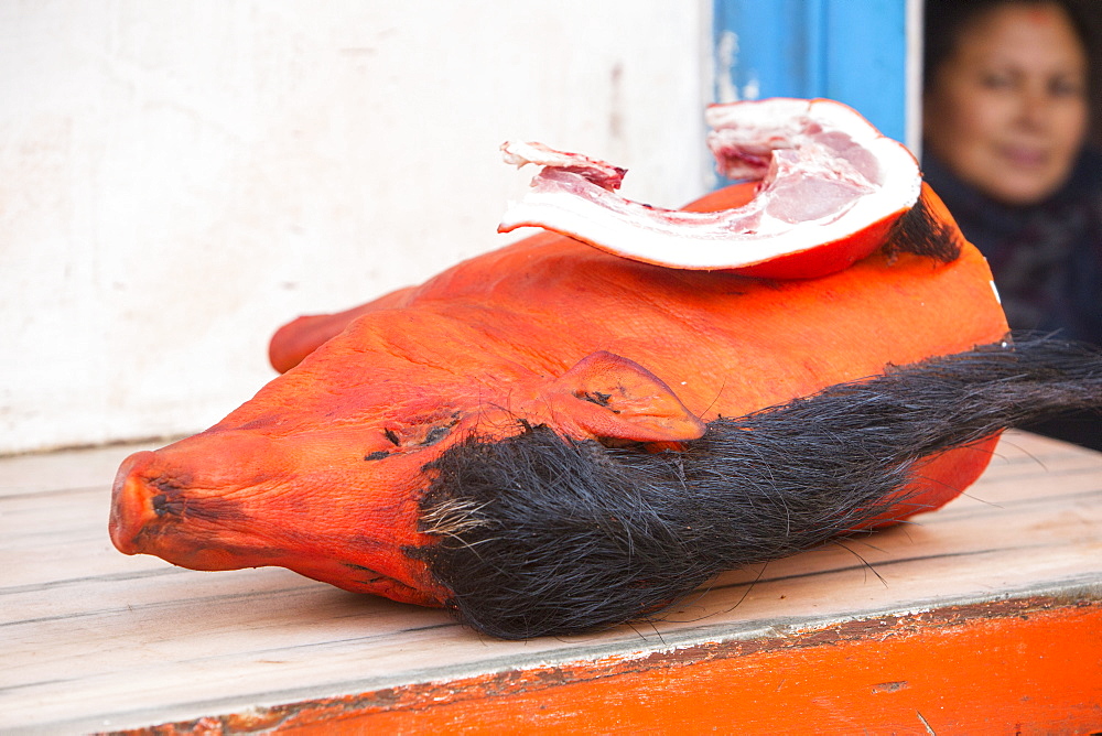 A dyed pig head on a butcher's shop slab in Kathmandu, Nepal, Asia