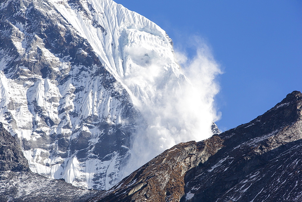 An avalanche on Machapuchare (Fishtail Peak) in the Annapurna Himalaya, Nepal, Asia