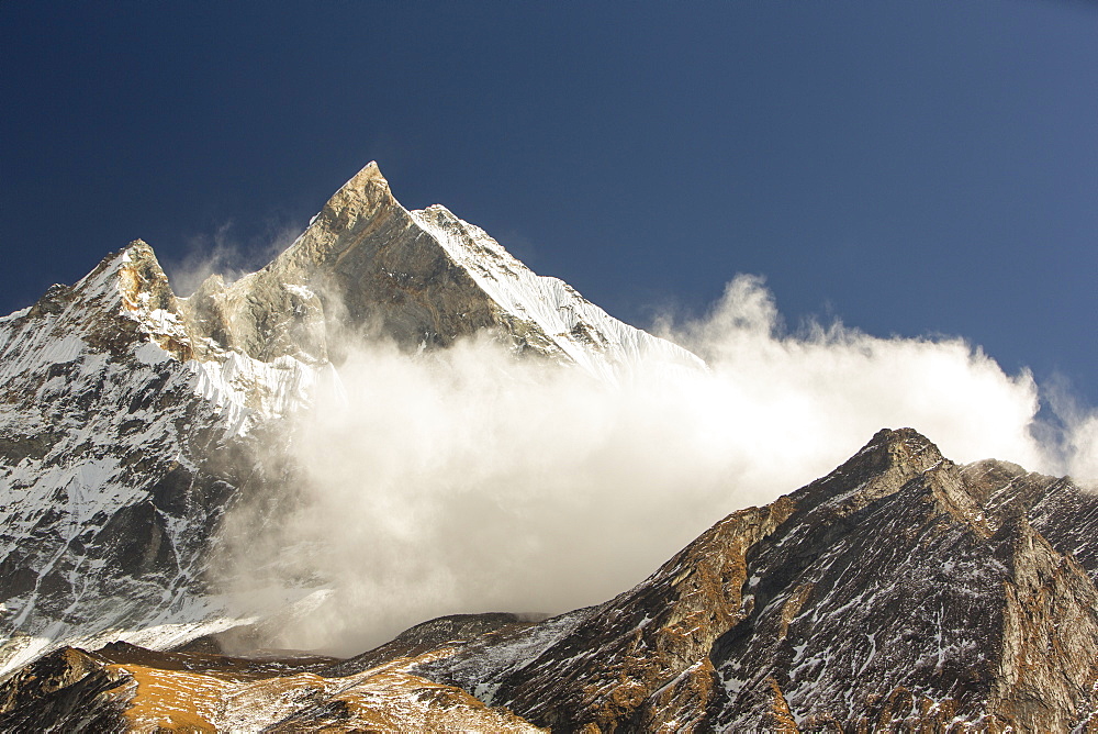 An avalanche on Machapuchare (Fishtail Peak) in the Annapurna Himalaya, Nepal, Asia