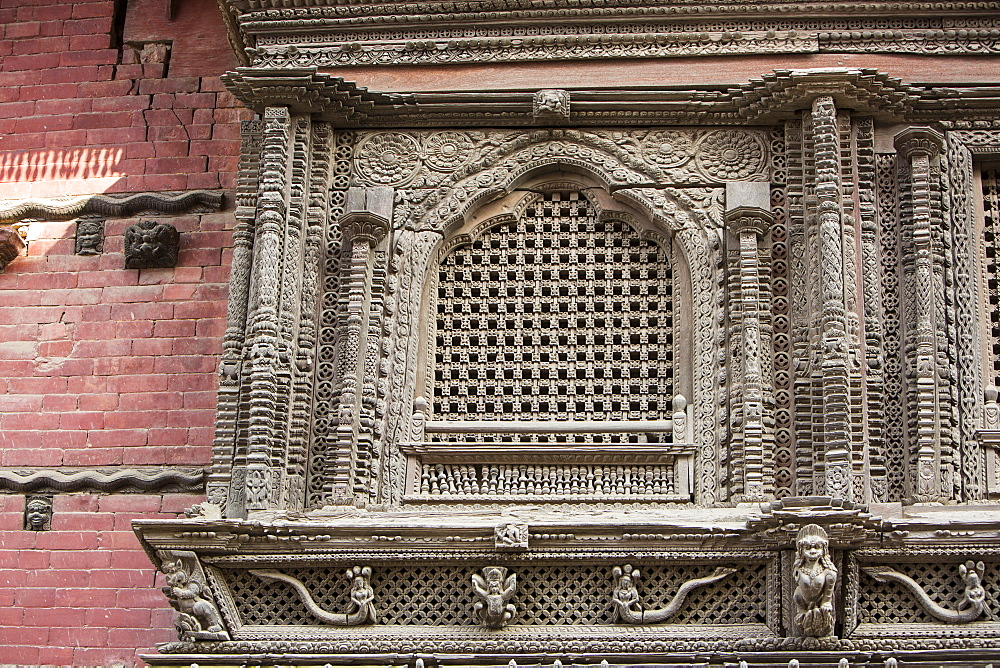 Ancient ornately carved wood window frames on an old building in Kathmandu's Durbar Square, UNESCO World Heritage Site, Kathmandu, Nepal, Asia