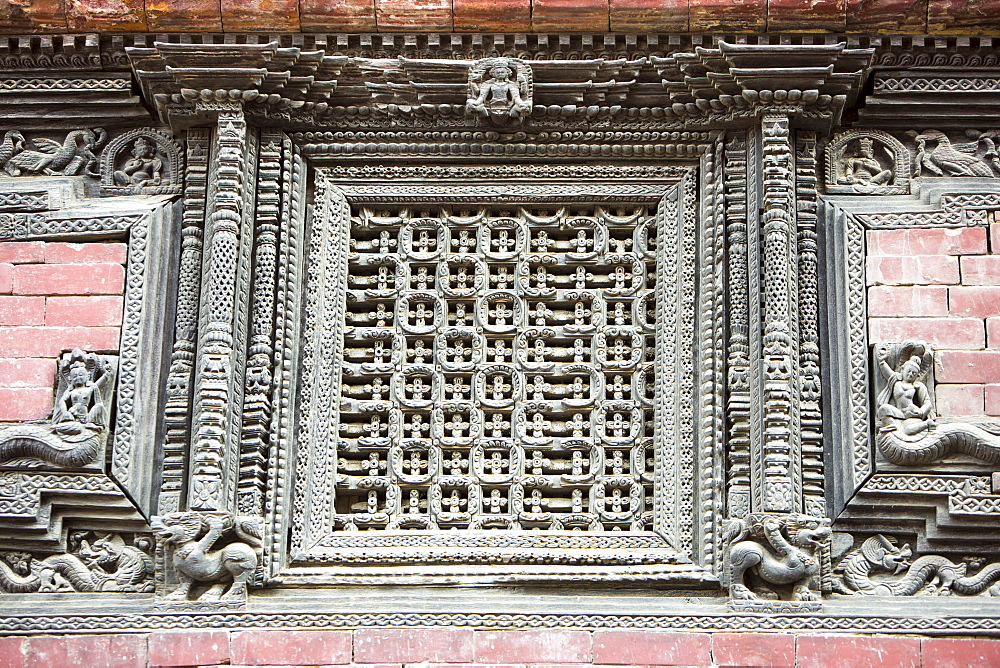 Ancient ornately carved wood window frames on an old building in Kathmandu's Durbar Square, UNESCO World Heritage Site, Kathmandu, Nepal, Asia