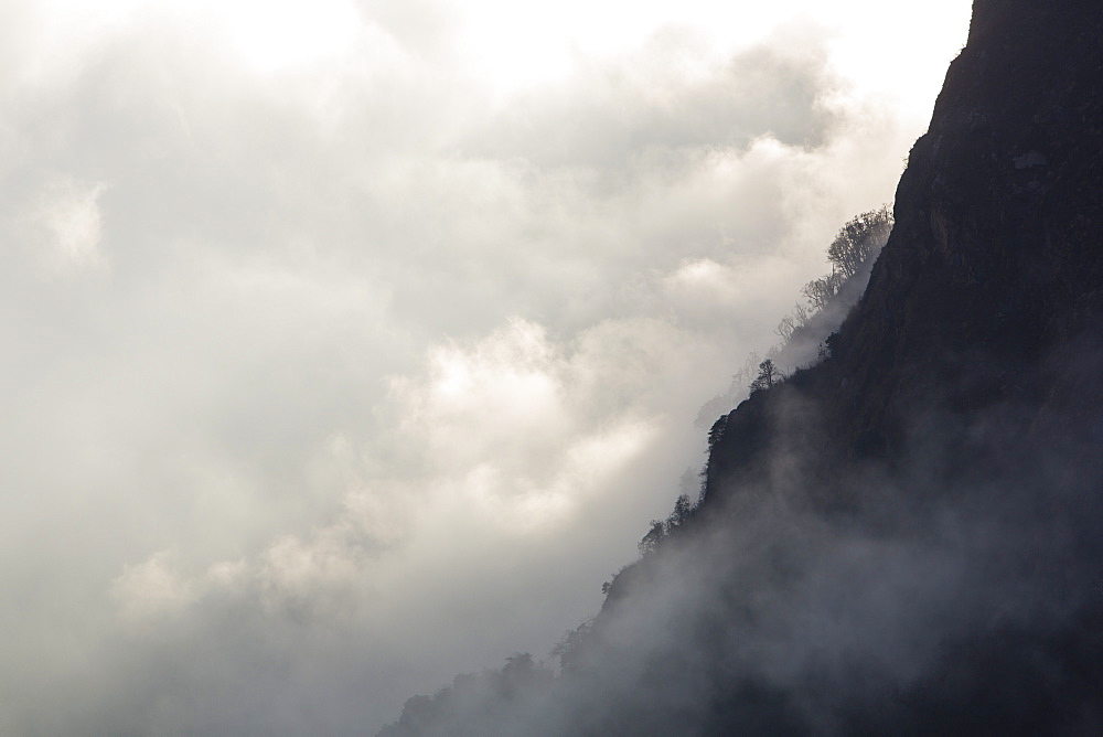 Mist moving up the Modi Khola valley in the Annapurna Sanctuary, in the Nepal Himalayas, Nepal, Asia