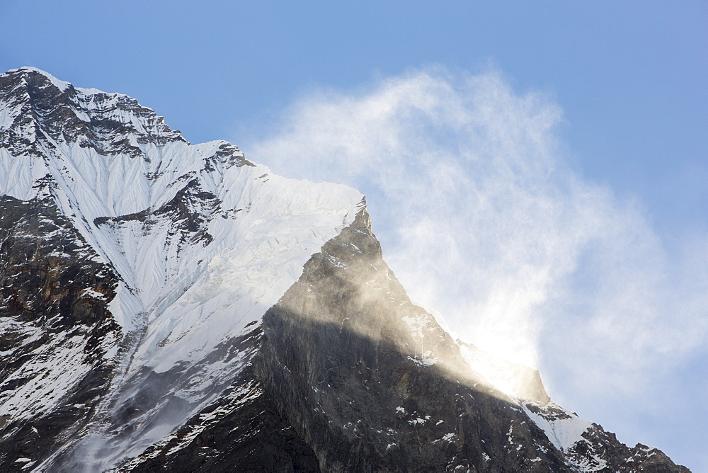 Machapuchare (Fish Tail Pea) in the Annapurna Himalayas with high winds blowing spindrift off the summit, Nepal, Asia