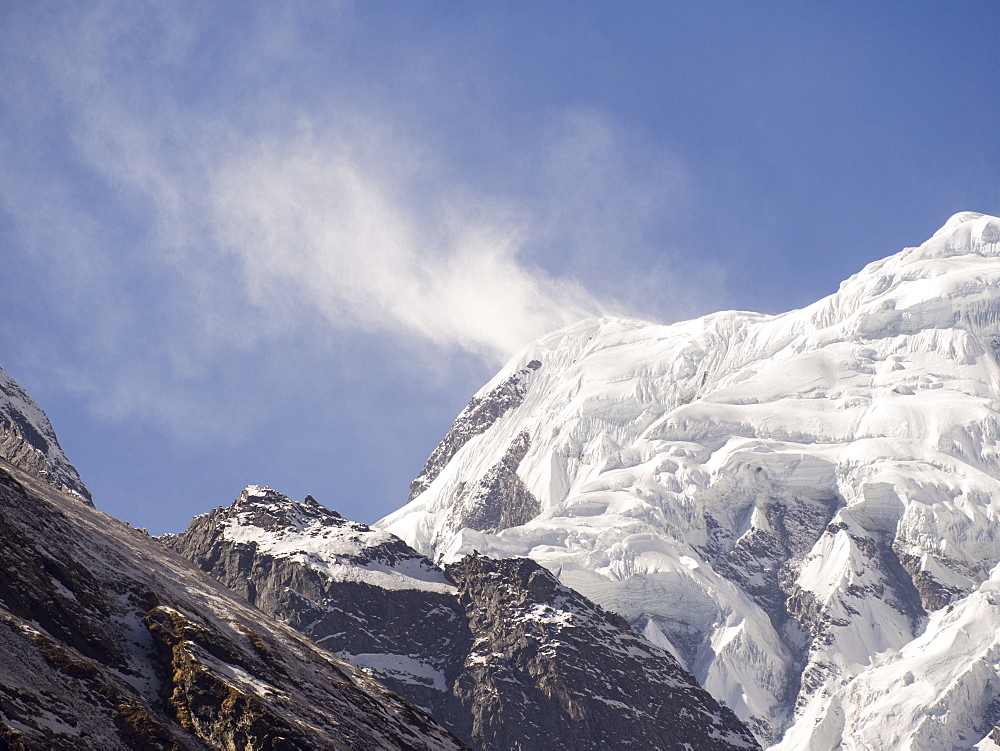 Annapurna South with high winds pushing spindrift off the summit, Annapurna Sanctuary, Himalayas, Nepal, Asia