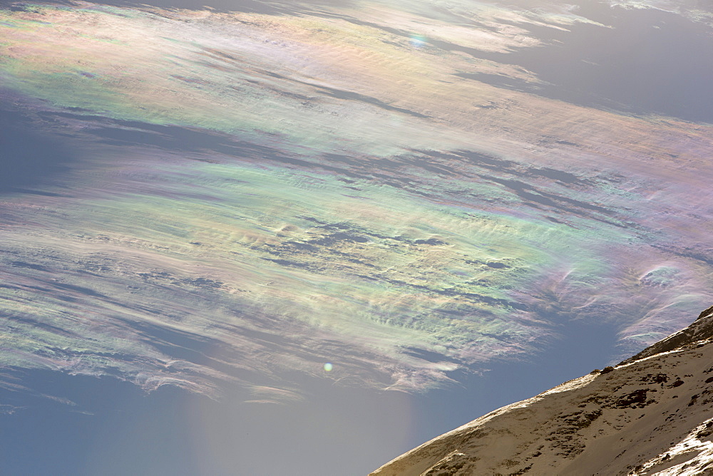 Jet stream winds over the Annapurna Himalayas with rainbow colours caused by refraction on ice crystals in the clouds, known as parhelion or sundog, Nepal, Asia