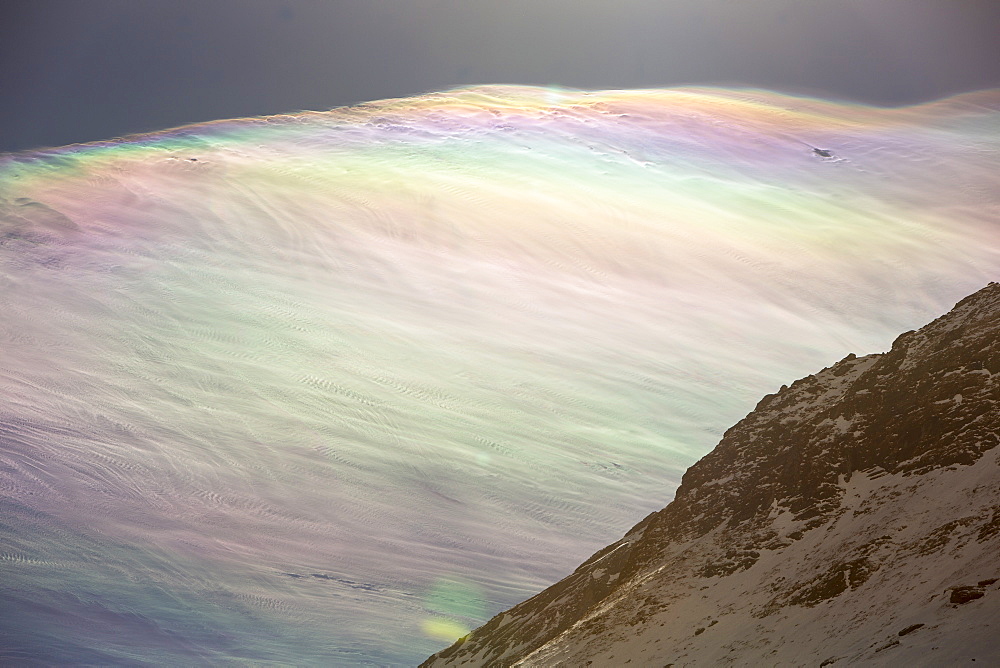 Jet stream winds over the Annapurna Himalayas with rainbow colours caused by refraction on ice crystals in the clouds, known as parhelion or sundog, Nepal, Asia