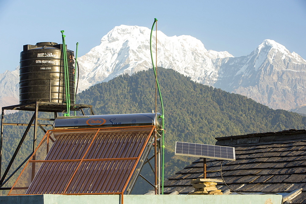 Solar thermal panels for heating water with solar photo voltaic panels on the rooftops of a tea house in the Himalayan foothills, Nepal, Asia