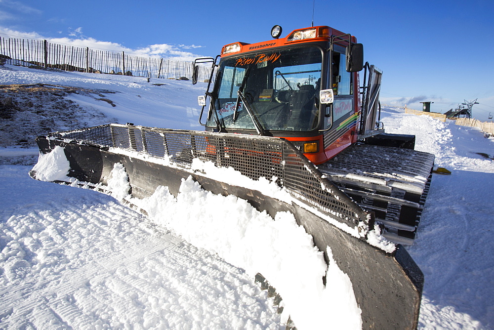 A piste basher on a ski run in the Cairngorm mountains, Scotland, United Kingdom, Europe