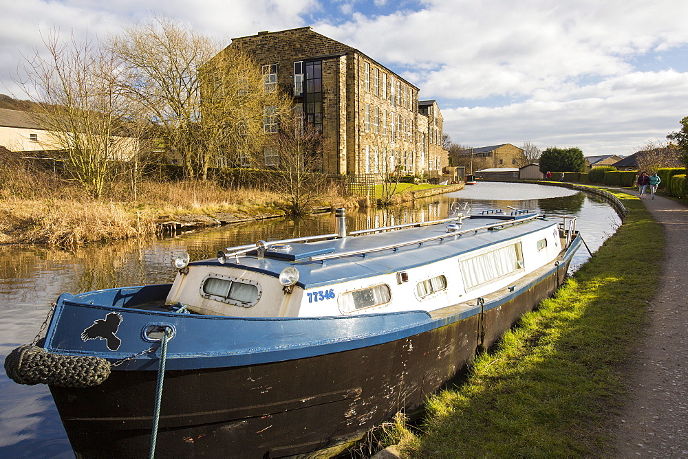 An old cotton mill converted into housing on the Leeds Liverpool Canal at Bingley, West Yorkshire, England, United Kingdom, Europe