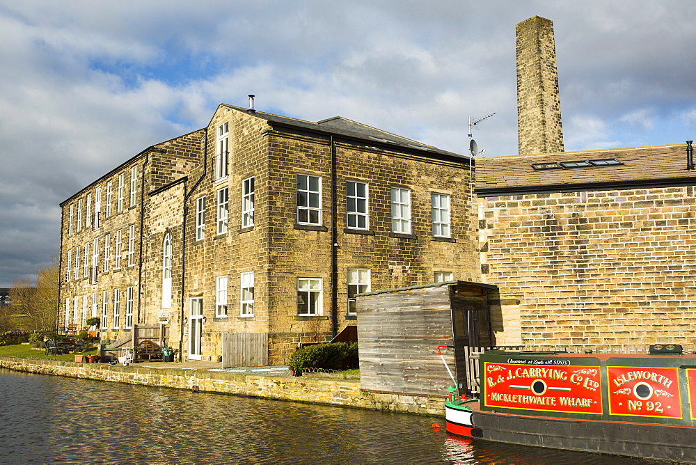 An old cotton mill converted into housing on the Leeds Liverpool Canal at Bingley, West Yorkshire, England, United Kingdom, Europe