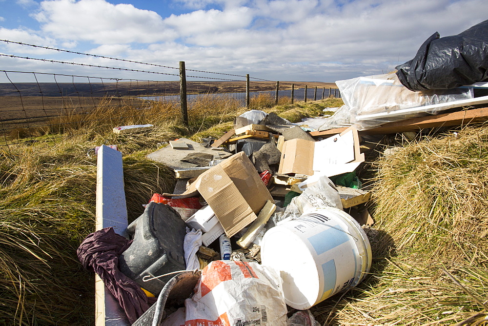 Fly tipped builders waste on Ovenden Moor near Warley Moor Reservoir above Keighley, West Yorkshire, Yorkshire, England, United Kingdom, Europe