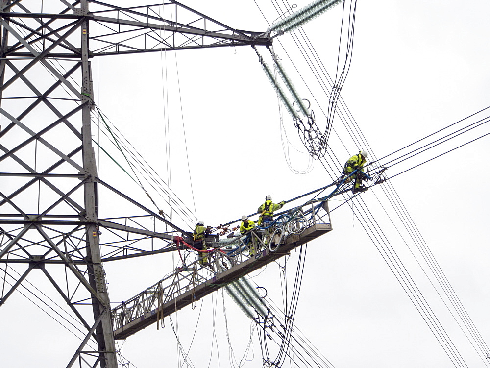 Technicians working to replace old insulators on a pylon in Barrow on Soar, Leicestershire, England, United Kingdom, Europe