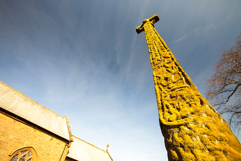 An ancient Anglo Saxon cross depicting Norse mythology in Gosforth church yard, Cumbria, England, United Kingdom, Europe