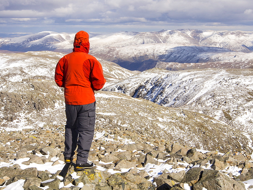 A hill walker on the summit of Scafell Pike, the highest mountain in England, Lake District, Cumbria, England, United Kingdom, Europe