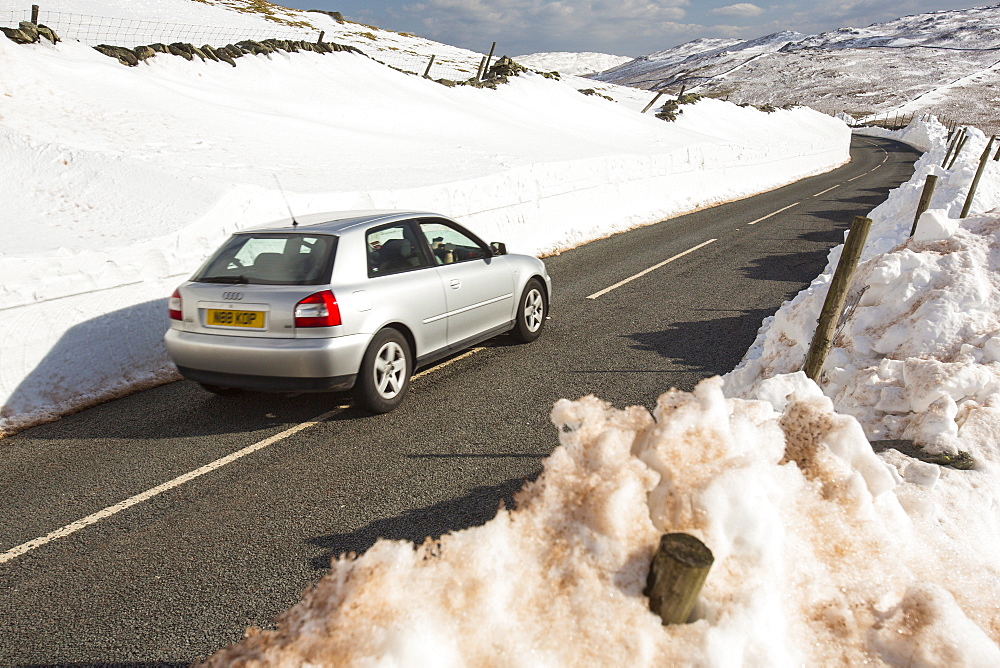 Massive snow drifts on the side of the Kirkstone Pass road during the extreme weather event of late March 2013, above Ambleside in the Lake District, Cumbria, England, United Kingdom, Europe