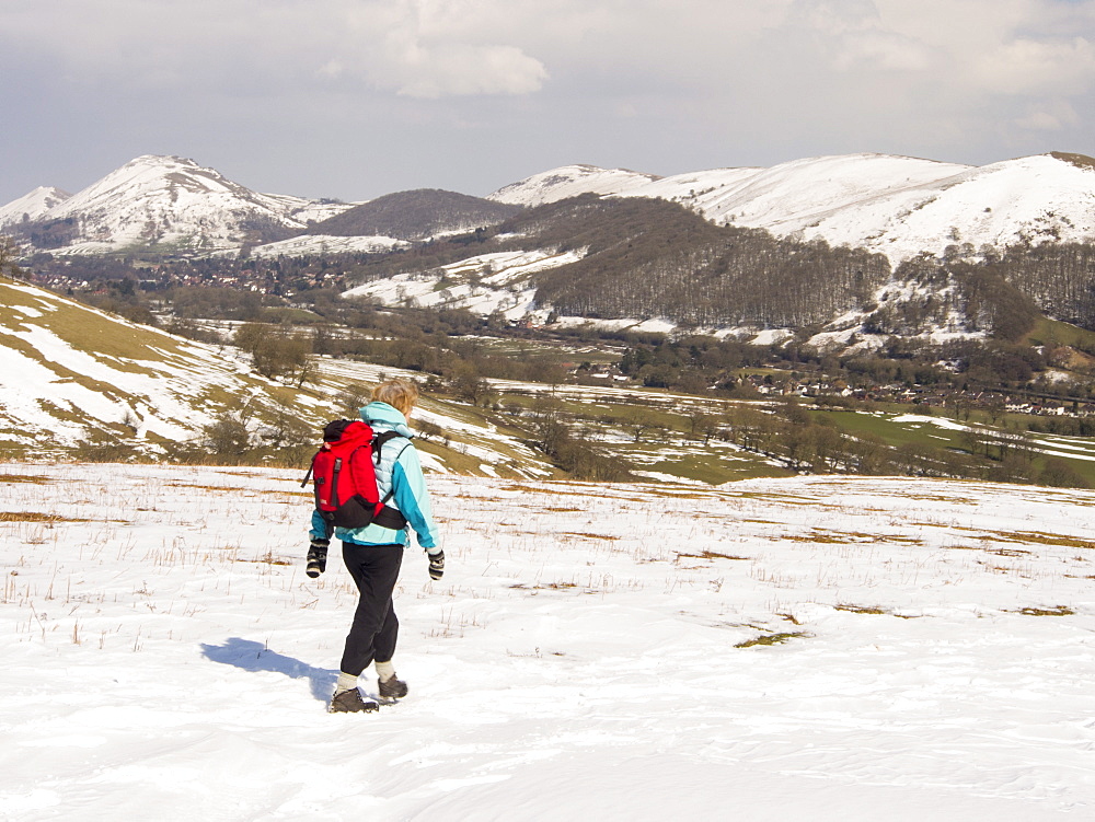 A walker on the Long Mynd, looking towards Caer Caradoc, above Church Stretton, Shropshire, England, United Kingdom, Europe