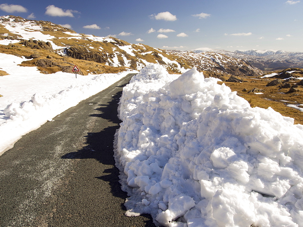 Massive snow drifts on the side of the Wrynose Pass road during the extreme weather event of late March 2013, Lake District, Cumbria, England, United Kingdom, Europe