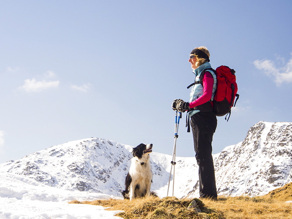 A woman fell walker on Wet Side Edge looking towards Great Carrs in the Lake District, Cumbria, England, United Kingdom, Europe