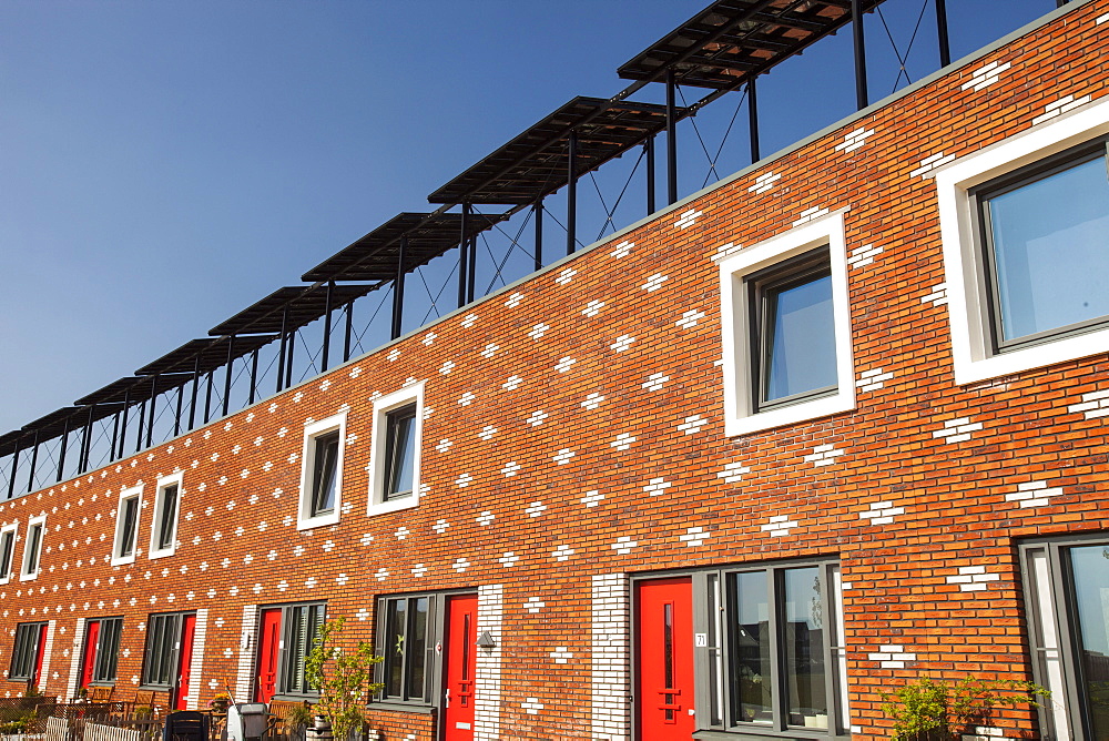 Houses in Almere with solar PV panels on the roof, Flevoland, Netherlands, Europe