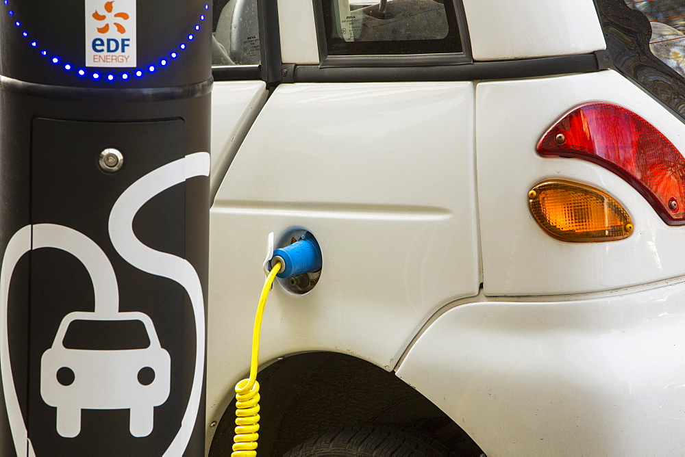 A G Wizz electric car at a pavement recharging station in London, England, United Kingdom, Europe