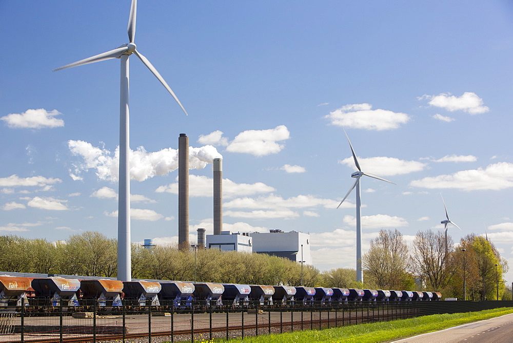 Climate change heaven and hell of a wind turbine with emissions from a coal fired power station in Amsterdam, Netherlands, Europe