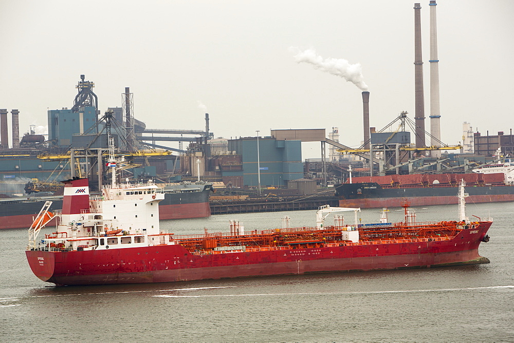 The oil tanker, Spring, importing oil into Holland past the Tata steel plant at Ijmuiden, Netherlands, Europe