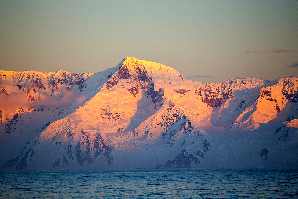 Evening light over mountains from the Gerlache Strait separating the Palmer Archipelago from the Antarctic Peninsular off Anvers Island. The Antartic Peninsular is one of the fastest warming areas of the planet.