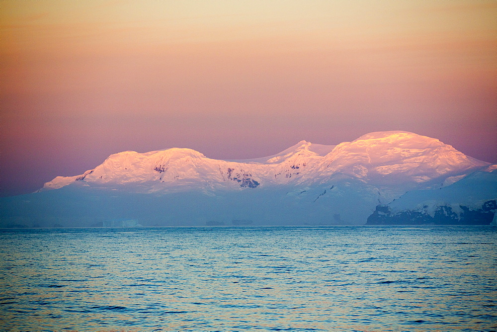 Evening light over mountains from the Gerlache Strait separating the Palmer Archipelago from the Antarctic Peninsular off Anvers Island. The Antartic Peninsular is one of the fastest warming areas of the planet.