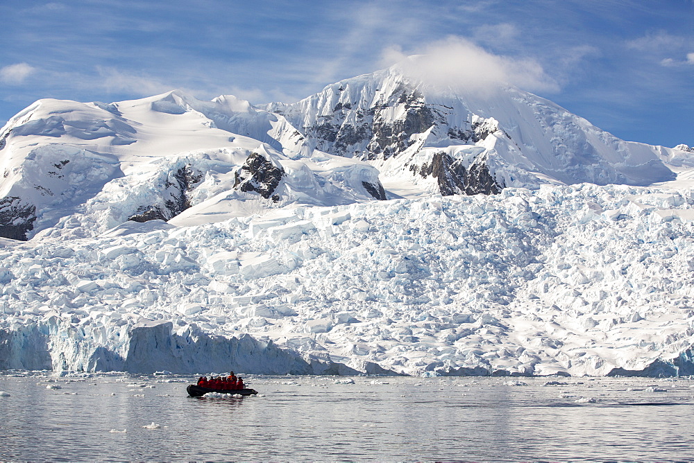 Members of an expedition cruise to Antarctica in a Zodiak in Paradise Bay beneath Mount Walker on the Antarctic Peninsular. The Antarctic Peninsular is one of the most rapidly warming areas on the planet.