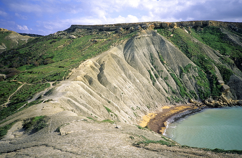 Cliffs made from soft grey clay sediments, Gnejna Bay, Ghajn Tuffieha, Malta, Mediterranean