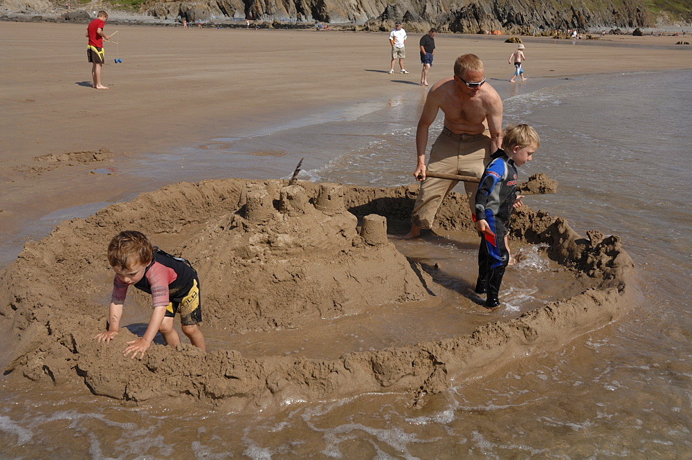 Building sandcastle, Marloes Sands, Pembrokeshire, Wales, UK