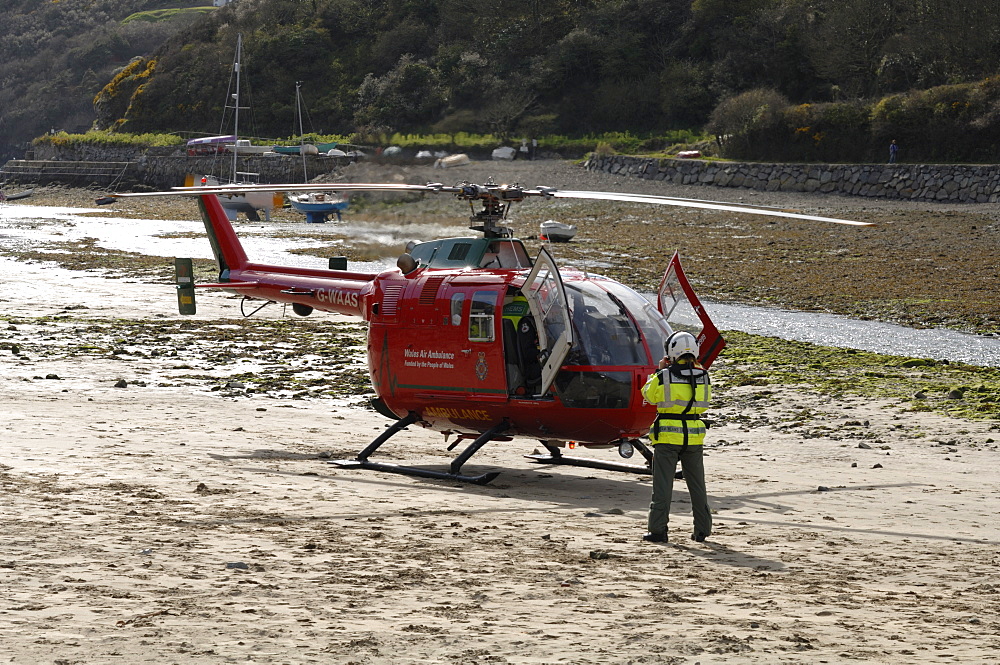 Wales Air Ambulance helicopter and crew rescuing a casualty at Solva harbour, Solva, Pembrokeshire, Wales, UK, Europe