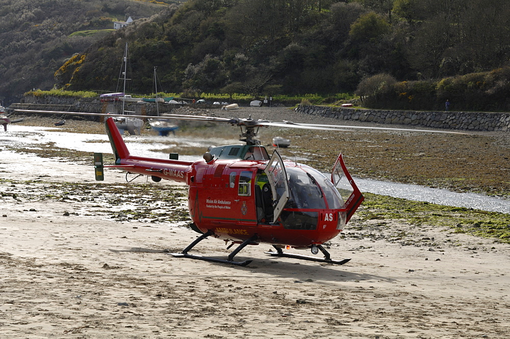 Wales Air Ambulance helicopter and crew rescuing a casualty at Solva harbour, Solva, Pembrokeshire, Wales, UK, Europe