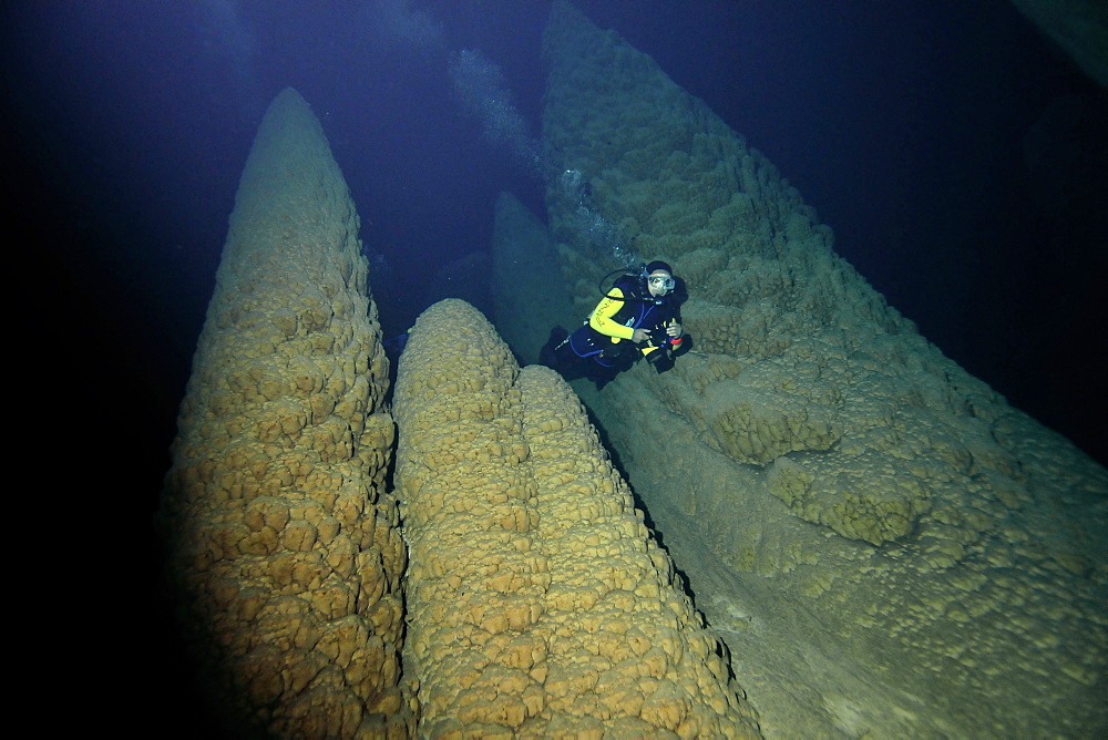 Scuba diver explores underwater cones in cave, Anhumas abyss, Bonito, Mato Grosso do Sul, Brazil, South America