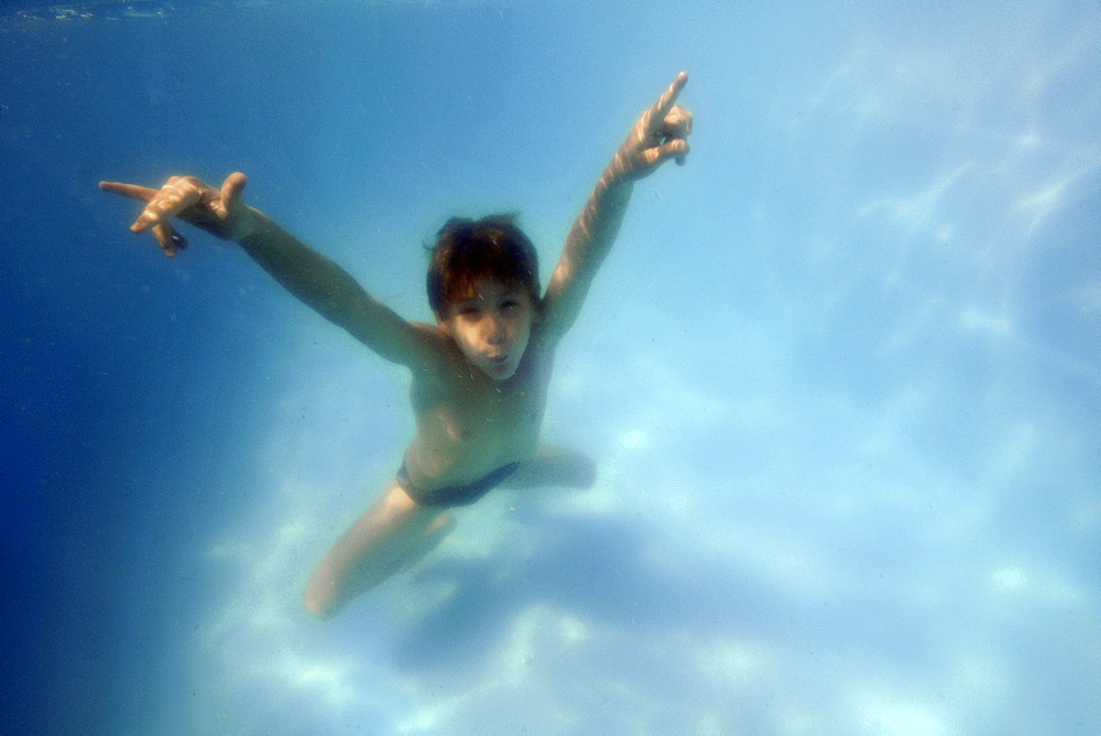 Young boy having underwater fun in the family pool, Guararema, Sao Paulo, Brazil, South America