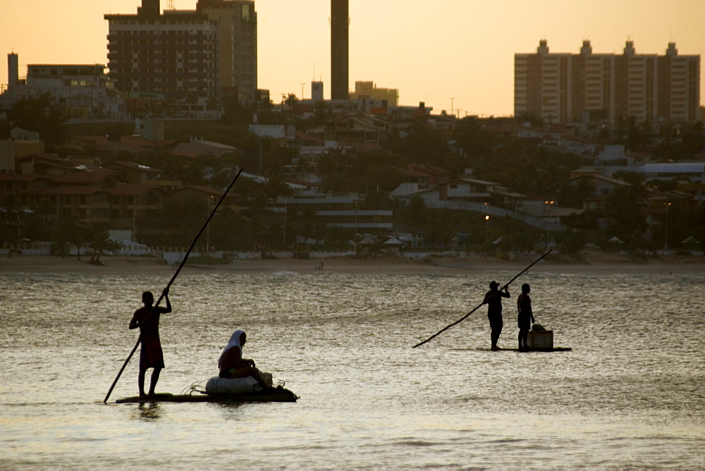 Fishermen in a traditional fishing raft at dusk, Natal, Rio Grande do Norte, Brazil, South America