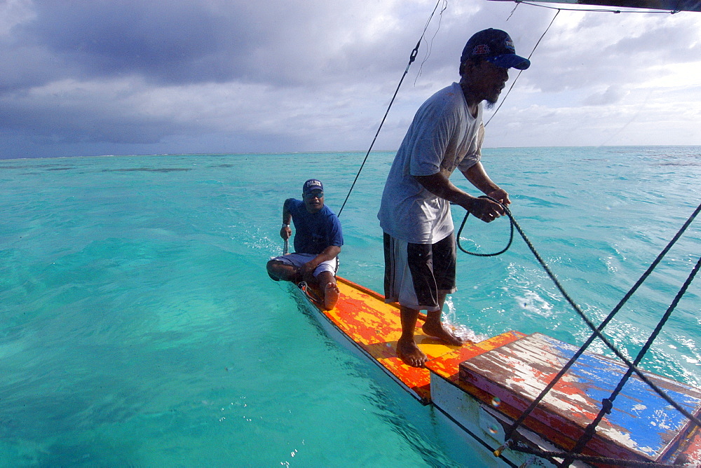 Marshalhese men steering a traditional outrigger canoe, Ailuk atoll, Marshall Islands, Pacific