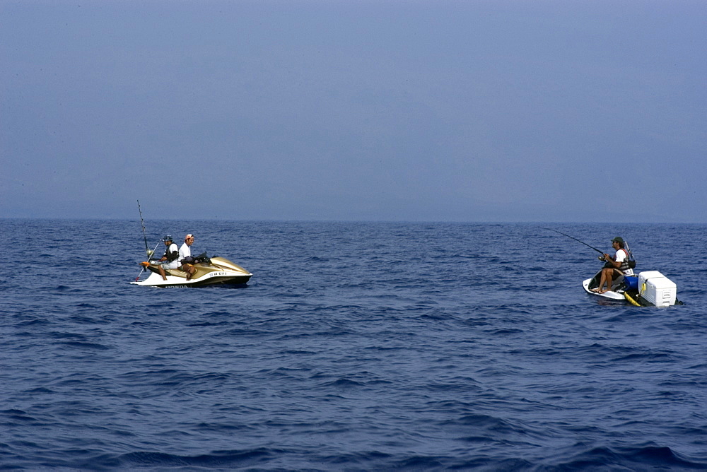 Local fishermen use jet ski to fish for skipjack tuna or aku, Big Island, Hawaii, United States of America, Pacific