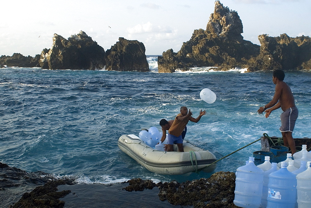 Fishermen transporting empty water containers, St. Peter and St. Paul's rocks, Brazil, South America